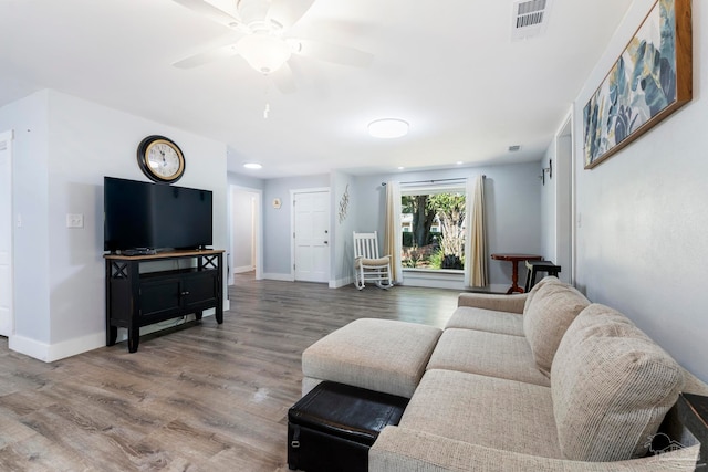 living room featuring ceiling fan and hardwood / wood-style floors