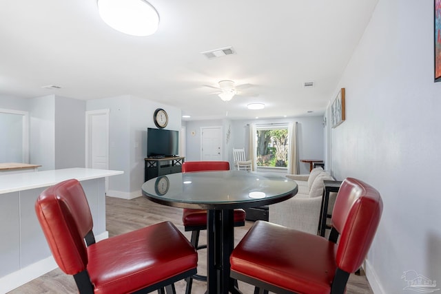 dining space featuring light hardwood / wood-style flooring and ceiling fan