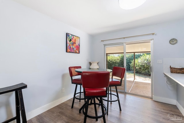 dining space with wood-type flooring