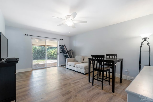 living room featuring ceiling fan and hardwood / wood-style flooring