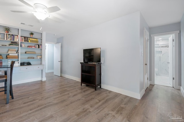 unfurnished living room with ceiling fan and light hardwood / wood-style flooring