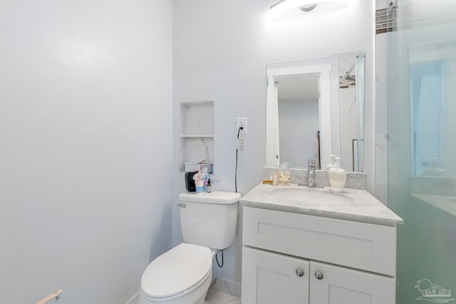 bathroom with vanity, a shower with shower door, and toilet