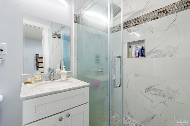 bathroom with walk in shower and vanity