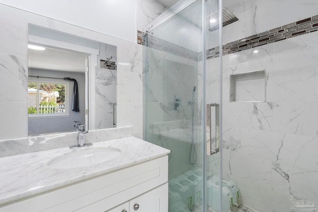 bathroom featuring vanity and a shower with door