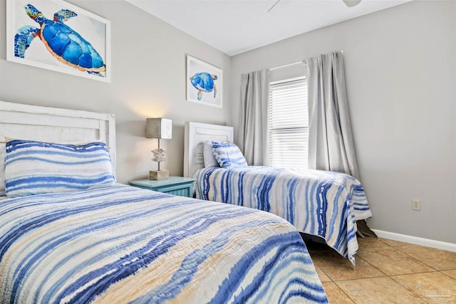 tiled bedroom featuring ceiling fan