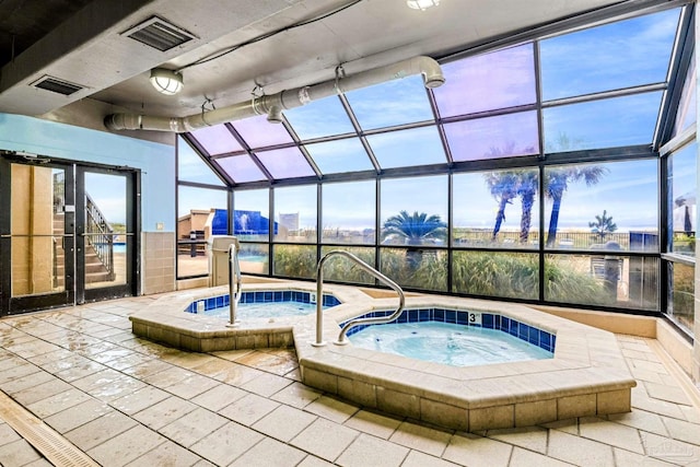 view of pool with an indoor hot tub