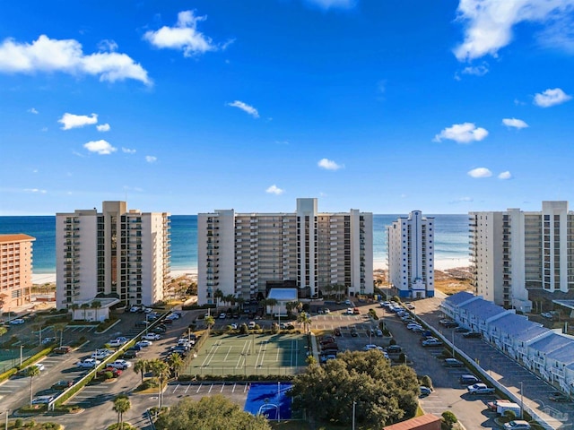 drone / aerial view featuring a water view and a beach view