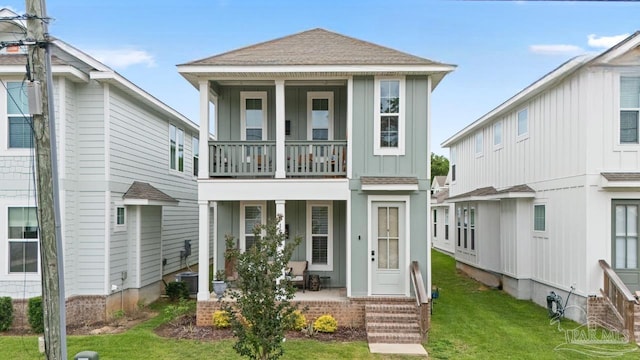 1550 W Romana St, Pensacola, FL 32502 - view of front of house featuring board and batten siding, a balcony, a front lawn, covered porch, and roof with shingles