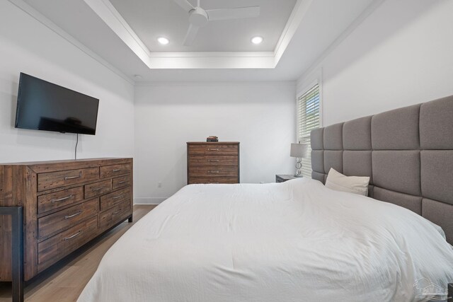 1550 W Romana St, Pensacola, FL 32502 - bedroom with a tray ceiling, wood finished floors, ornamental molding, ceiling fan, and recessed lighting