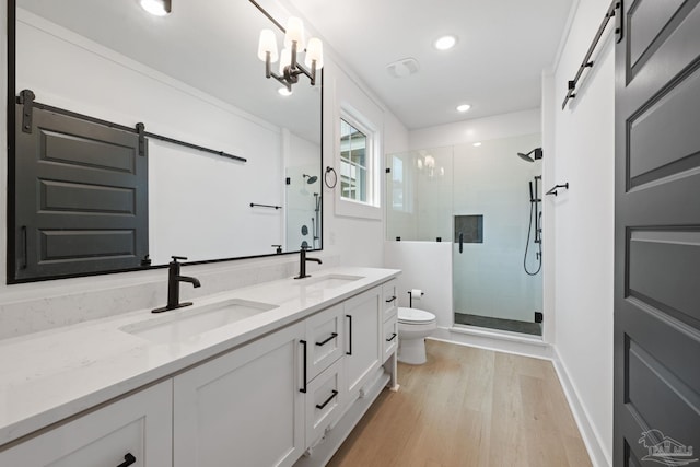 1550 W Romana St, Pensacola, FL 32502 - full bath with toilet, double vanity, a shower stall, wood finished floors, and recessed lighting