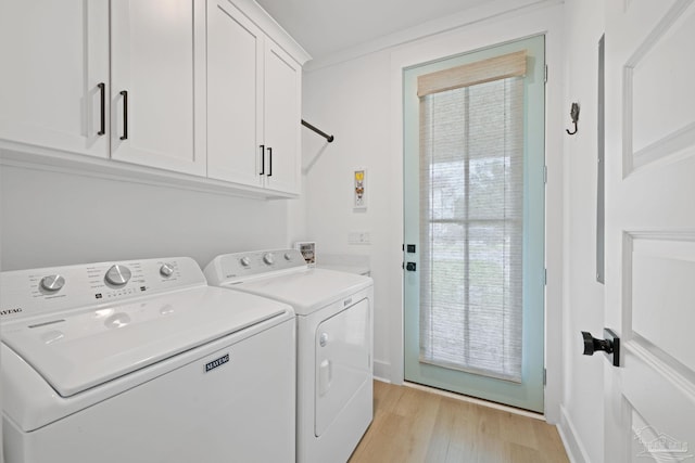 1550 W Romana St, Pensacola, FL 32502 - clothes washing area with cabinet space, washer and dryer, and light wood-type flooring