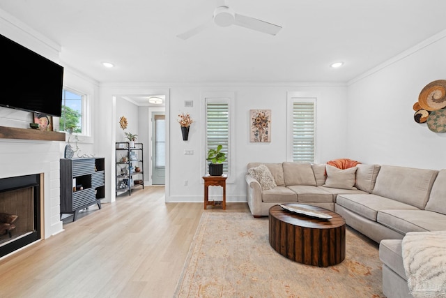 1550 W Romana St, Pensacola, FL 32502 - living area with light wood finished floors, crown molding, a fireplace, a ceiling fan, and baseboards
