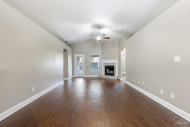 unfurnished living room featuring ceiling fan, dark hardwood / wood-style flooring, and vaulted ceiling