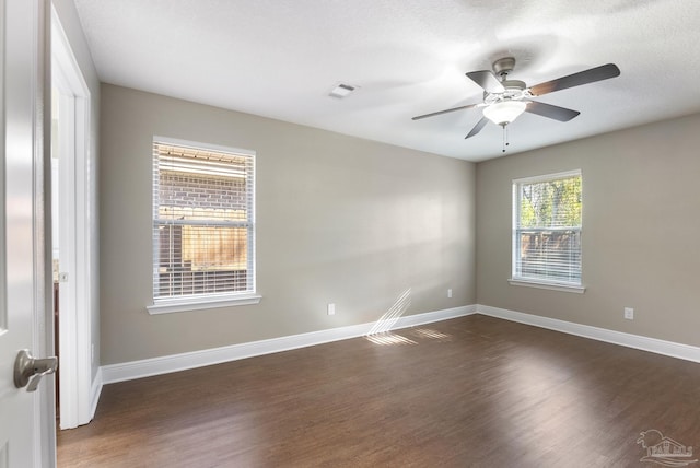 unfurnished room featuring ceiling fan and dark wood-type flooring