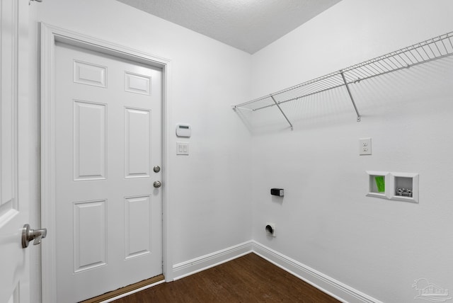 laundry room with washer hookup, hookup for an electric dryer, dark wood-type flooring, and a textured ceiling