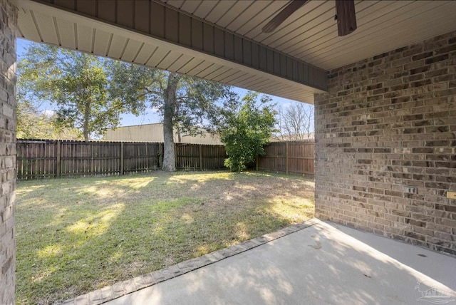 view of yard with a patio area and ceiling fan