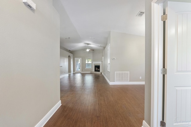 hallway featuring dark hardwood / wood-style flooring and lofted ceiling