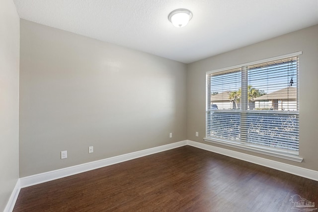 empty room featuring dark wood-type flooring