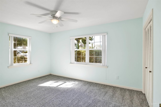 unfurnished bedroom featuring ceiling fan, a closet, and multiple windows