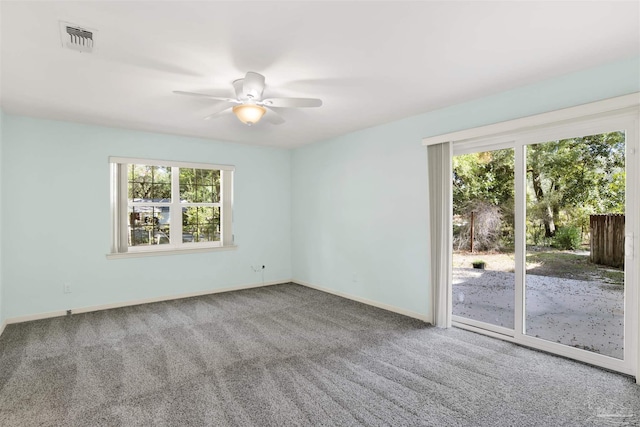 carpeted spare room with ceiling fan