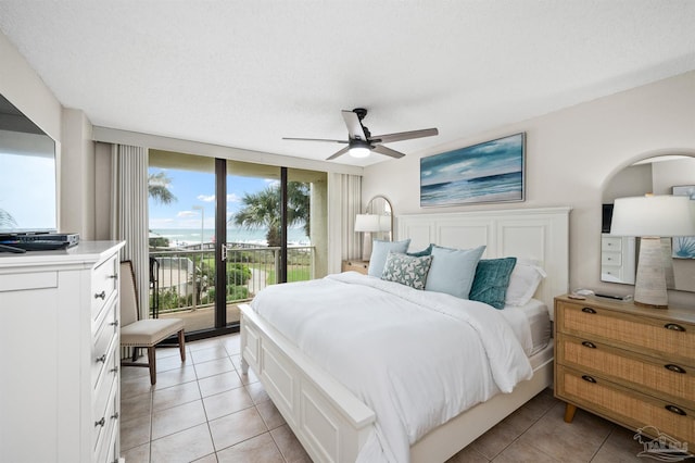 tiled bedroom with access to outside, ceiling fan, and a textured ceiling