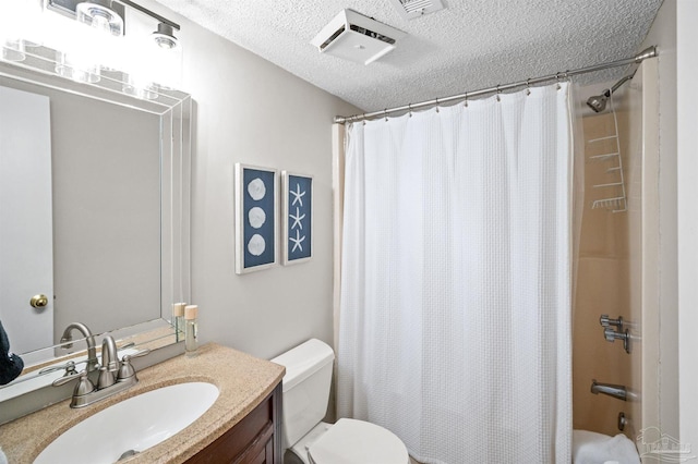 full bathroom featuring vanity, toilet, a textured ceiling, and shower / tub combo