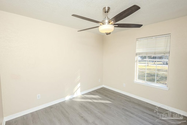 spare room with ceiling fan and wood-type flooring