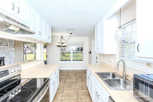 kitchen featuring electric range, decorative light fixtures, and white cabinetry