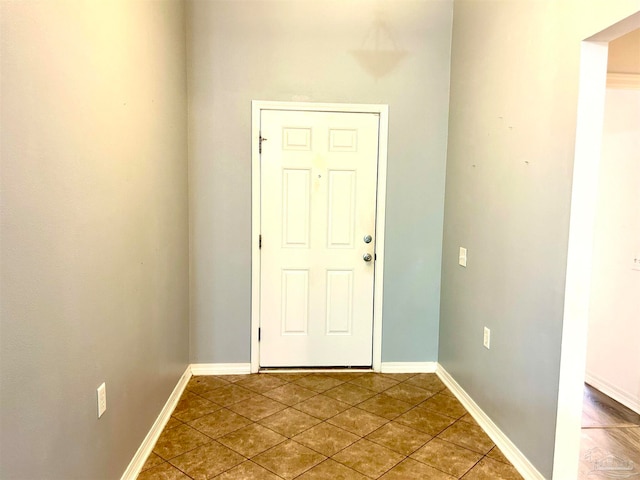 doorway to outside with light tile patterned floors