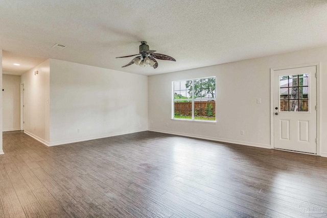 unfurnished room with dark hardwood / wood-style flooring, plenty of natural light, and ceiling fan