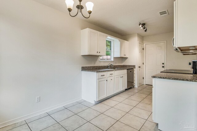 kitchen with stainless steel dishwasher, a notable chandelier, light tile patterned flooring, and white cabinetry