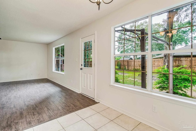 doorway with plenty of natural light and light tile patterned floors