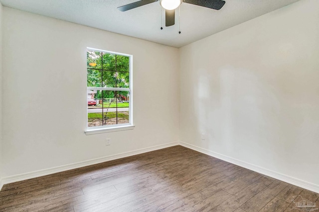 empty room featuring dark hardwood / wood-style flooring and ceiling fan