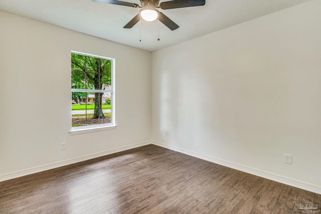 spare room with ceiling fan and dark wood-type flooring