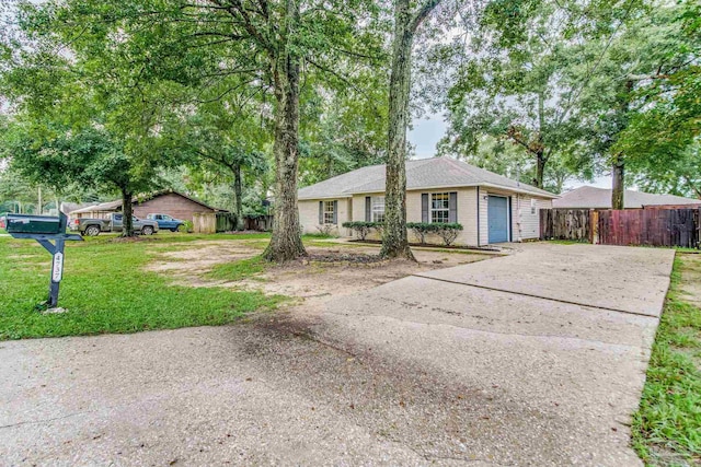 single story home with a garage and a front lawn