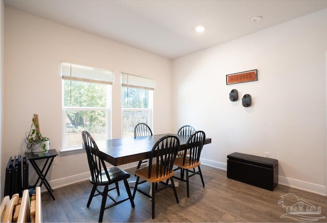 dining area with a healthy amount of sunlight and dark hardwood / wood-style flooring