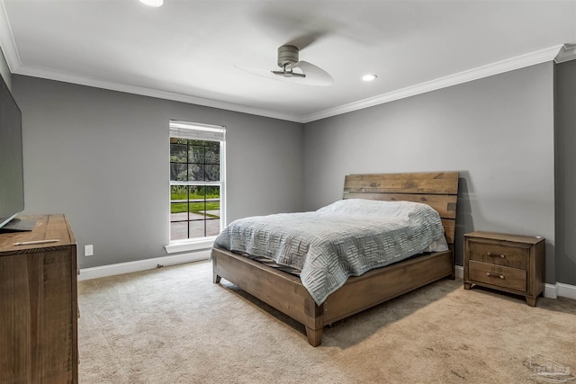 carpeted bedroom featuring ceiling fan and crown molding