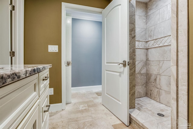 bathroom featuring vanity and tiled shower