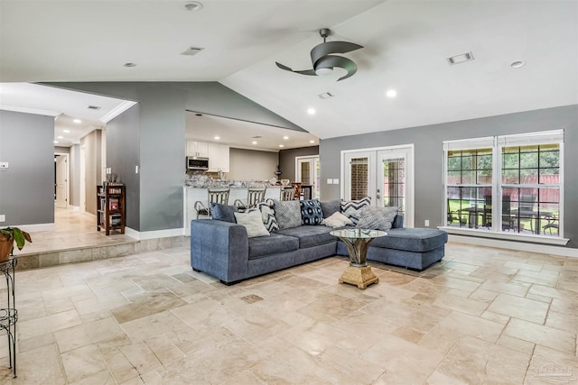 living room featuring ceiling fan, lofted ceiling, and french doors