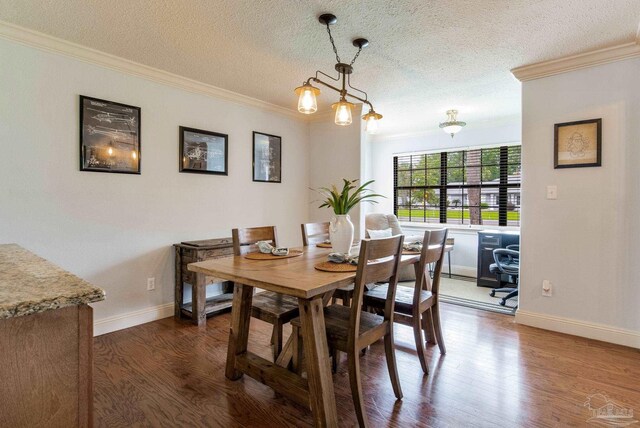 3905 Tiger Point Blvd, Gulf Breeze, FL 32563 - dining area featuring crown molding, dark wood-type flooring, a textured ceiling, and baseboards