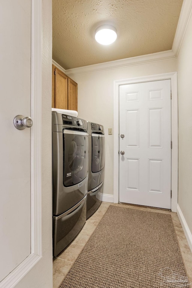 3905 Tiger Point Blvd, Gulf Breeze, FL 32563 - washroom featuring washing machine and dryer, cabinet space, a textured ceiling, crown molding, and light tile patterned floors