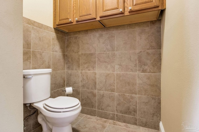 3905 Tiger Point Blvd, Gulf Breeze, FL 32563 - bathroom featuring toilet and tile walls