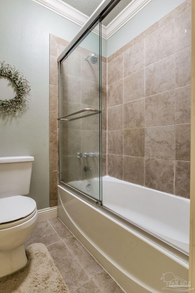 3905 Tiger Point Blvd, Gulf Breeze, FL 32563 - full bath with toilet, combined bath / shower with glass door, tile patterned floors, baseboards, and crown molding