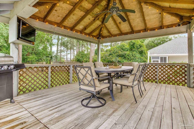 3905 Tiger Point Blvd, Gulf Breeze, FL 32563 - wooden terrace featuring a ceiling fan, outdoor dining area, and a gazebo