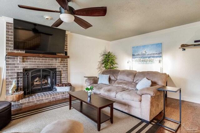 3905 Tiger Point Blvd, Gulf Breeze, FL 32563 - living area featuring wood finished floors, crown molding, a textured ceiling, a fireplace, and baseboards
