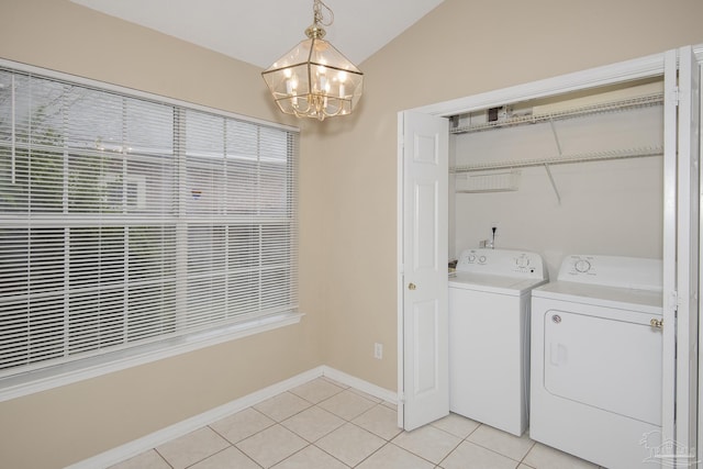 laundry room featuring separate washer and dryer, light tile patterned floors, and a chandelier