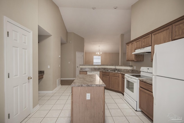 kitchen with sink, a kitchen island, decorative light fixtures, white appliances, and light tile patterned flooring