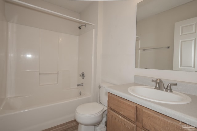 full bathroom with hardwood / wood-style floors, vanity, toilet, and washtub / shower combination