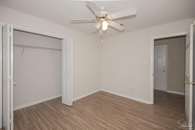 unfurnished bedroom featuring a closet, ceiling fan, and hardwood / wood-style flooring