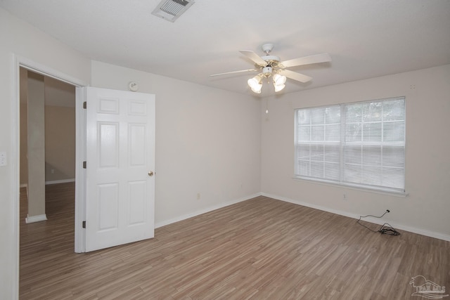 empty room featuring ceiling fan and light hardwood / wood-style floors